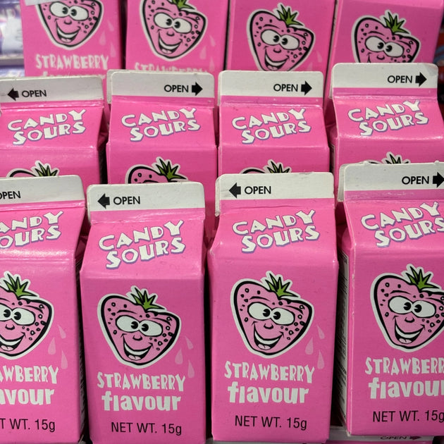 Small sour strawberry candy balls in a mini milk carton