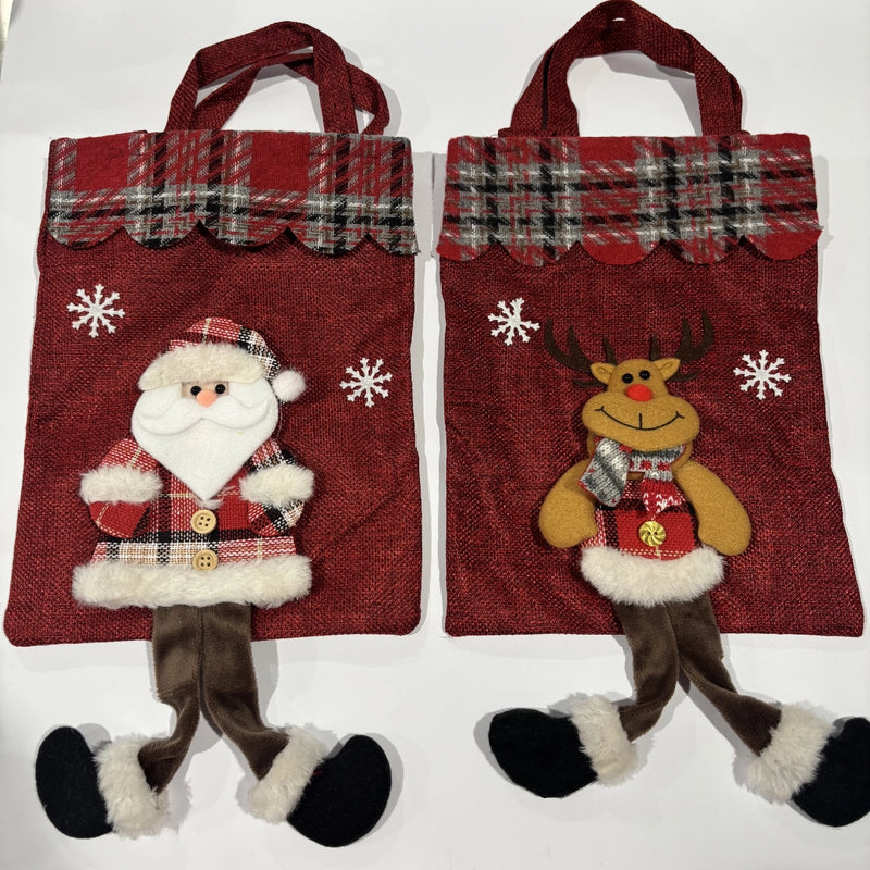 Red Christmas gift bag with Santa or reindeer design.