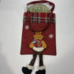 Red Christmas gift bag with Reindeer design, containing a large Christmas chocolate freckle.