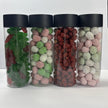 Four clear Christmas lolly tubes with black lids, filled with red and green frogs, colourful sugared peanuts and assorted bon bons.