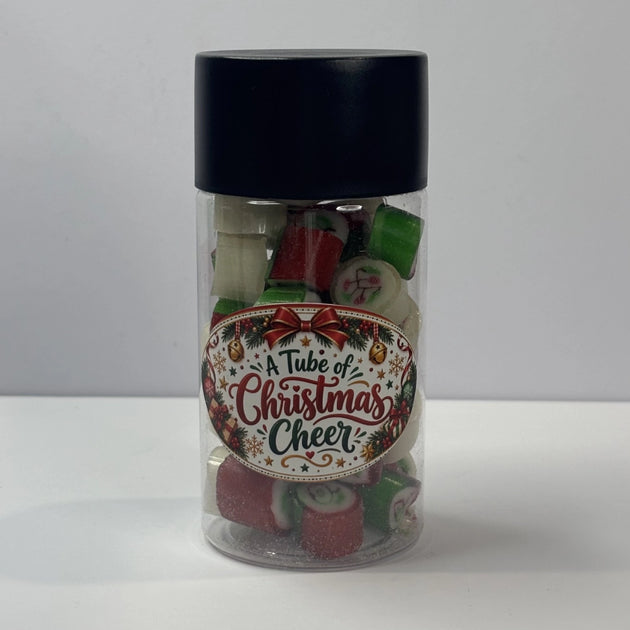 Pieces of Apple & Raspberry rock candy in a tube with a Christmas label