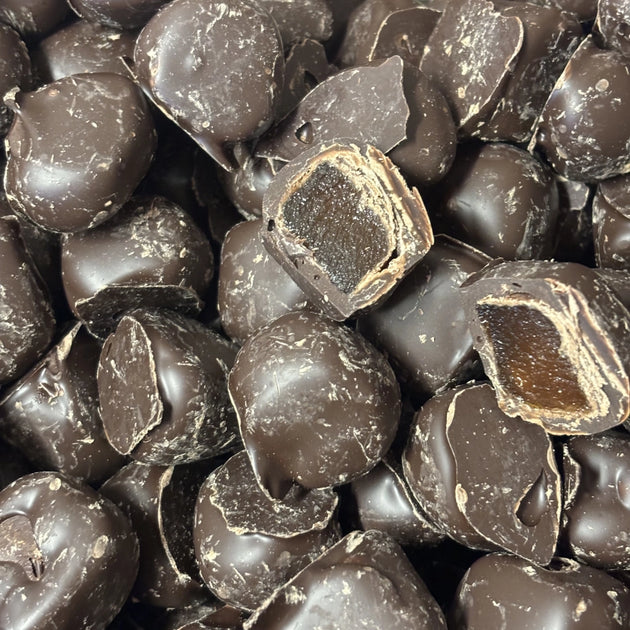 Pieces of brown ginger coated in dark chocolate