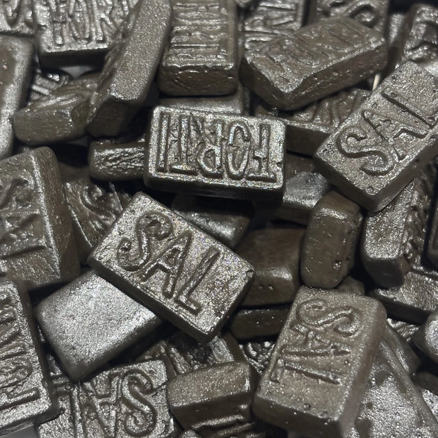 Dutch triple salt licorice pieces with words FORTI or SAL stamped on them