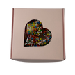 A square gift box with a heart-shaped clear window showing colorful chocolate freckles inside.