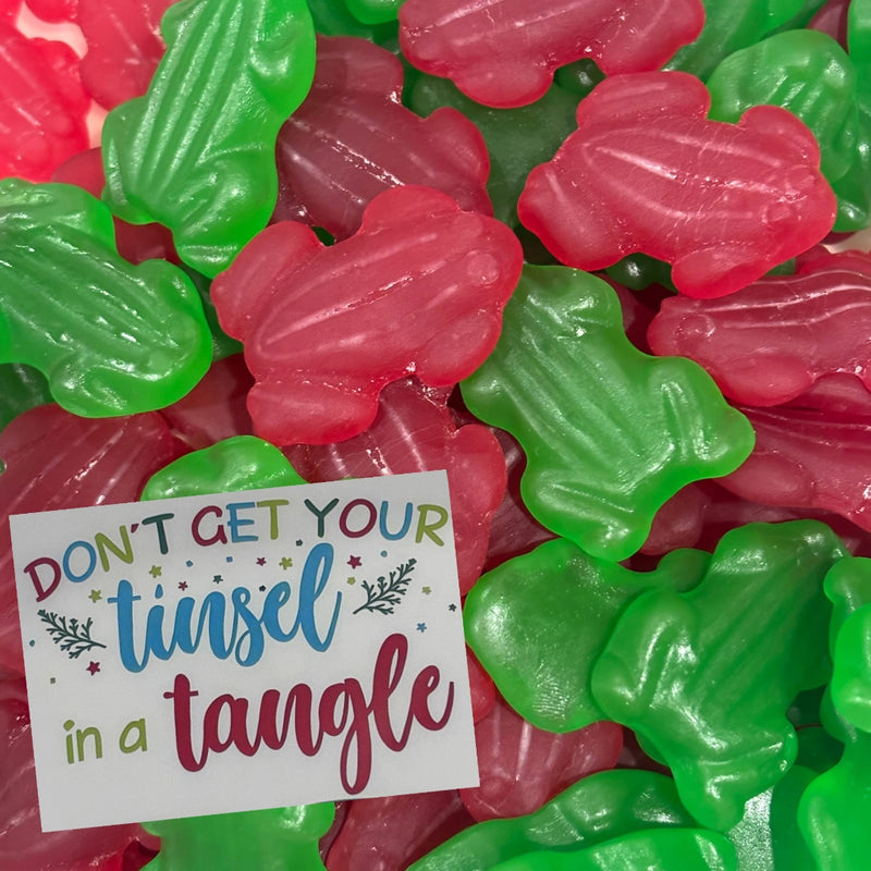 Don't Get Your Tinsel in a Tangle sign with red and green frog lollies
