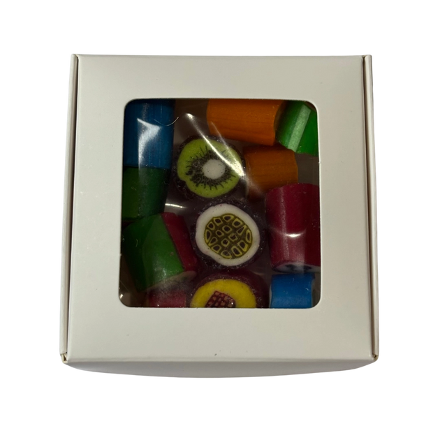 A square gift box with a clear plastic window showing fruit rock candy inside.