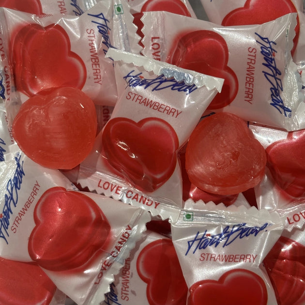 Red strawberry heart shaped lollies, individually wrapped. 