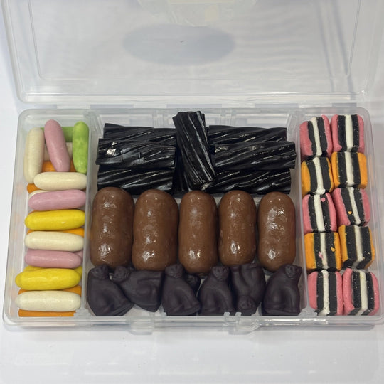 Snack box filled with assorted licorice confectionery, including colourful candy licorice bullets, black licorice twists, jumbo milk chocolate bullets, Black Cats and striped licorice allsorts.