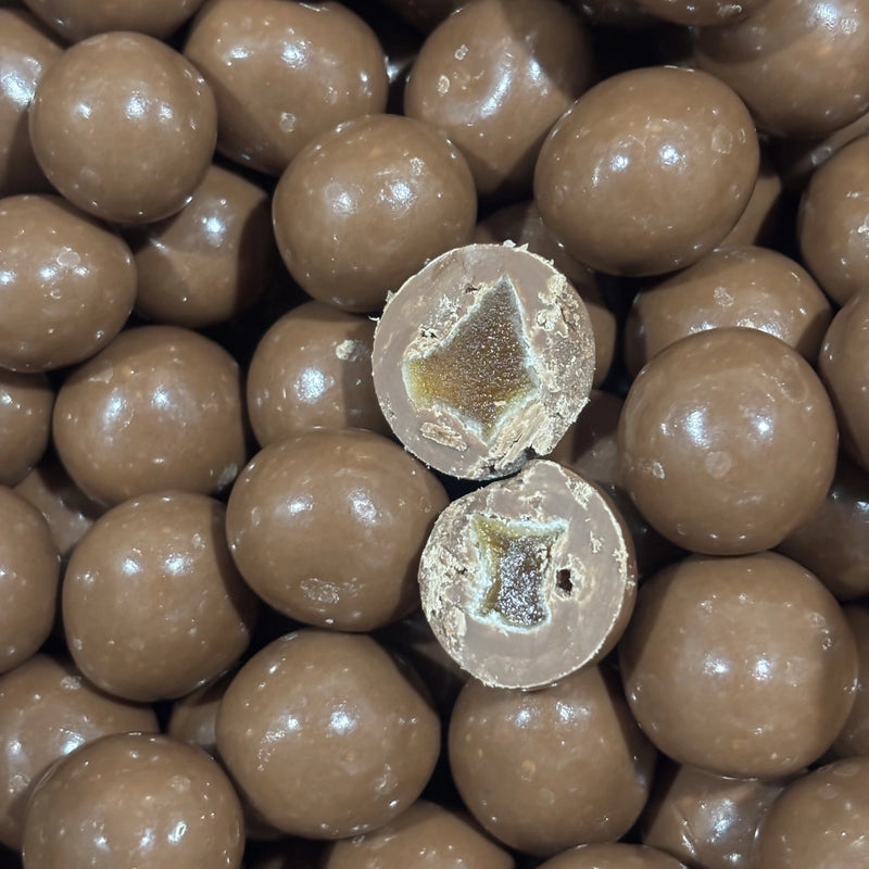 Pieces of ginger coated in milk chocolate