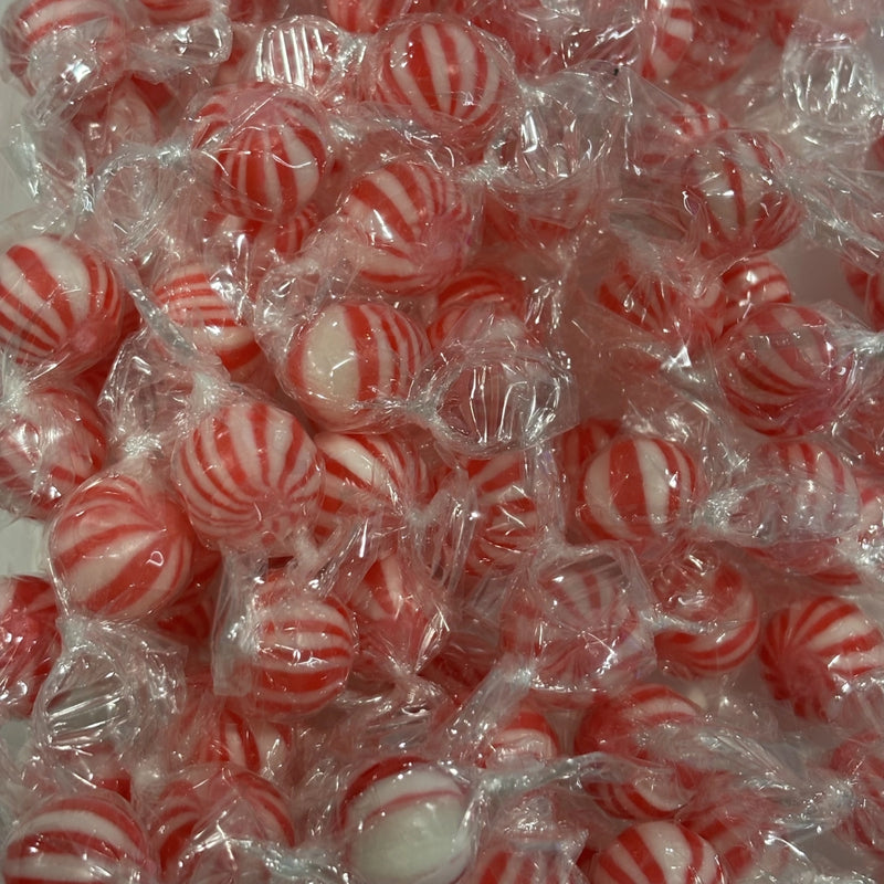 Individually wrapped red and white striped mint bauble boiled sweets with a festive candy cane appearance