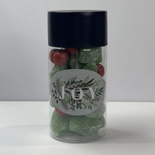 Green spearmint leave lollies and red jaffa balls in a tube with a Christmas label