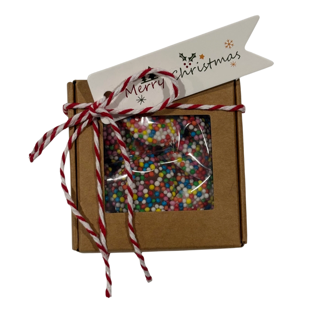 White and milk chocolate freckles with sprinkles in a Christmas gift box