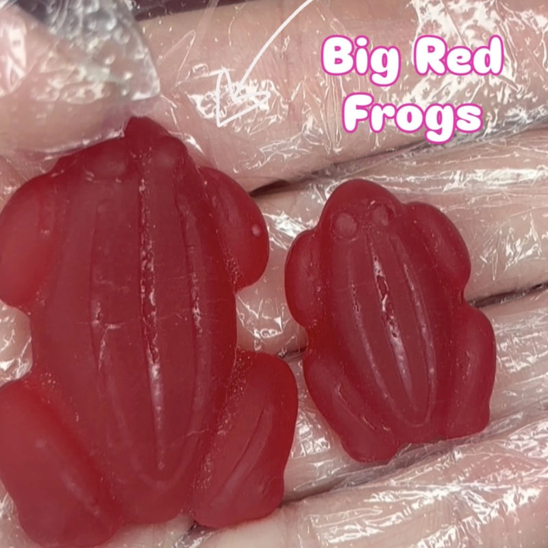 Two red frog shaped lollies varying in size - small and large
