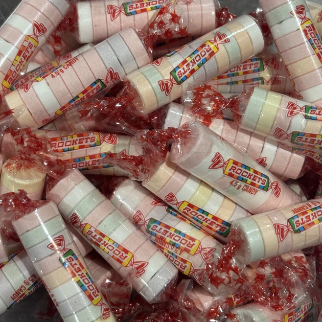 Pastel colour discs of fizzy lollies wrapped in a roll.