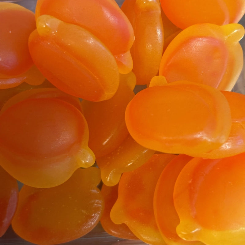 Orange and yellow peach-shaped NZ sour peach lollies