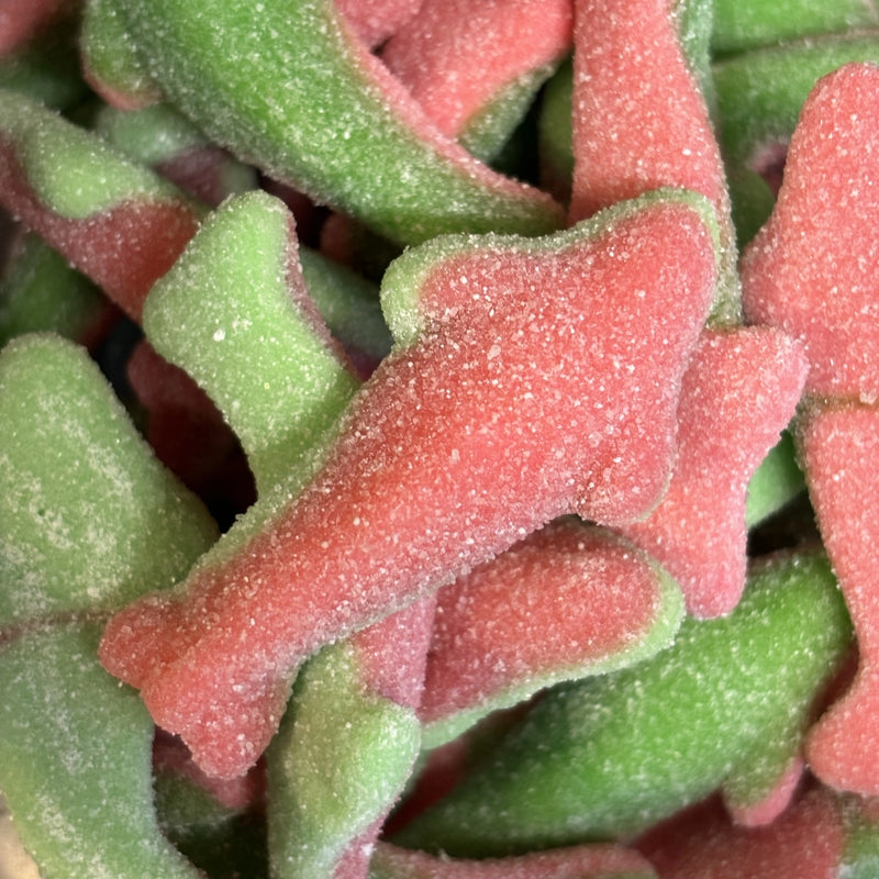 Pink and green sour watermelon shark-shaped lollies coated in sugar