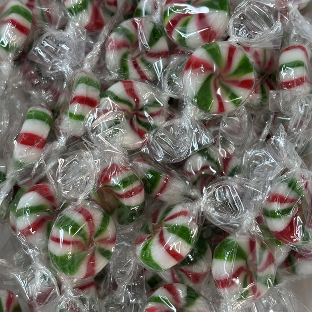 Individually wrapped Starlight Mints featuring red, green and white peppermint swirls in traditional round boiled sweets.