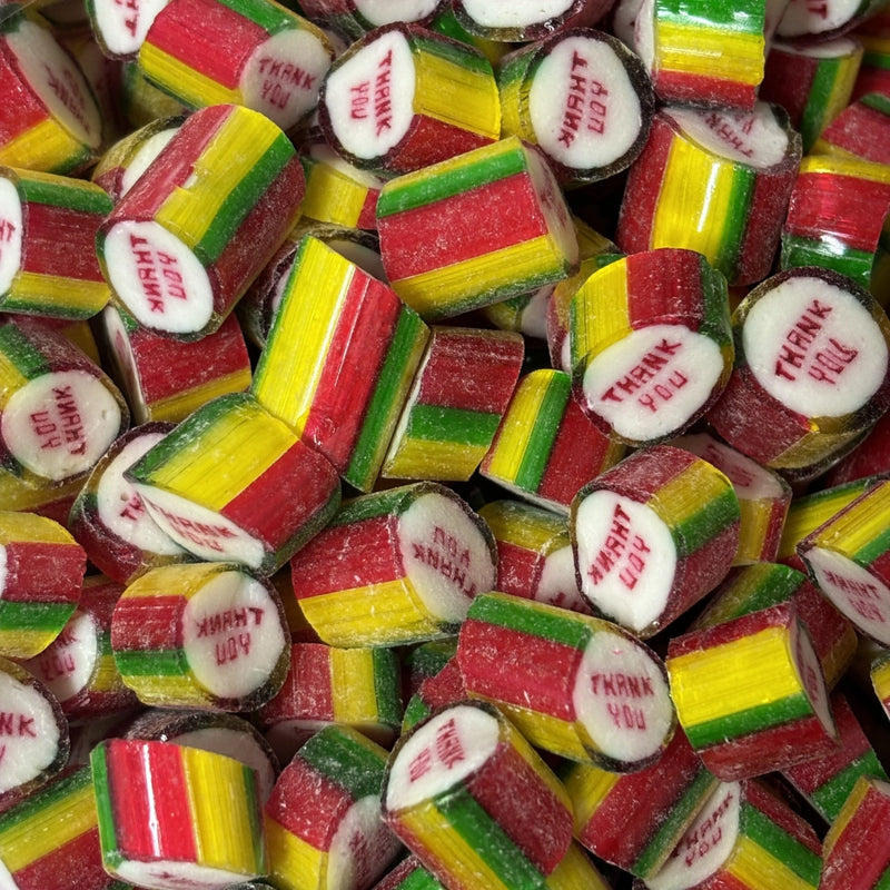 Pieces of green, yellow and red rock candy with Thank You message printed in the middle