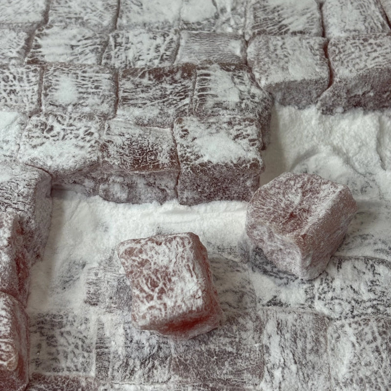 Pink squares of rose flavoured Turkish Delight dusted with icing sugar