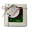 A square gift box containing green and pink watermelon rock candy inside, tied with a string and a 'Happy Birthday' gift tag.
