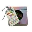 A square gift box with a circular window showing green and pink watermelon rock candy inside, tied with a string and a thank-you tag that reads 'THANK YOU for all that you do! YOU ARE APPRECIATED MORE THAN YOU KNOW!'