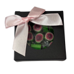 A square gift box with a round clear window showing green and pink watermelon rock candy inside, decorated with a bow.