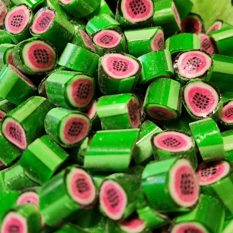 Pieces of green rock candy lollies with watermelon image in the middle of each piece