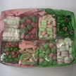 Assorted pink and green lollies in box
