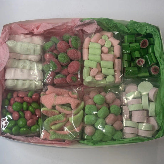 Assorted pink and green lollies in box