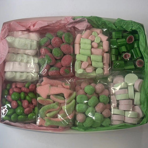 Assorted pink and green lollies in box