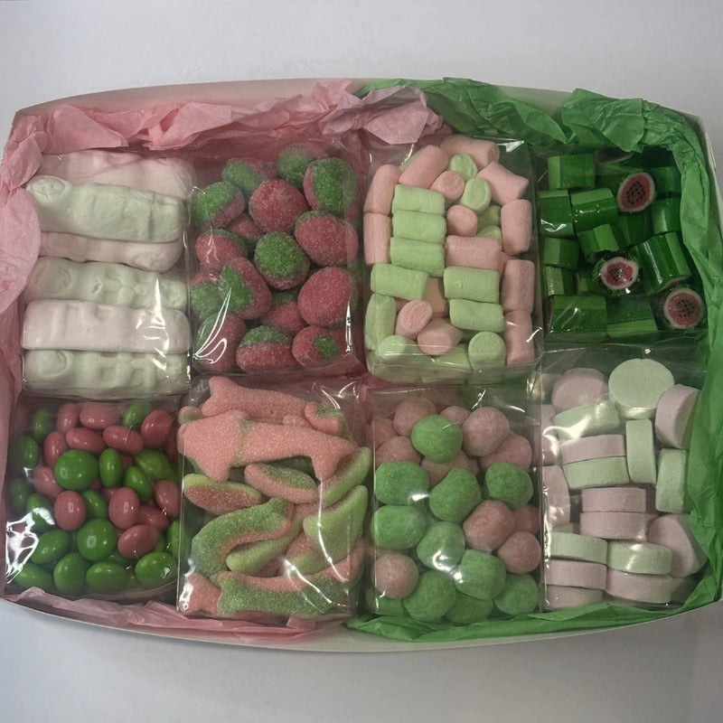 Assorted pink and green lollies in box