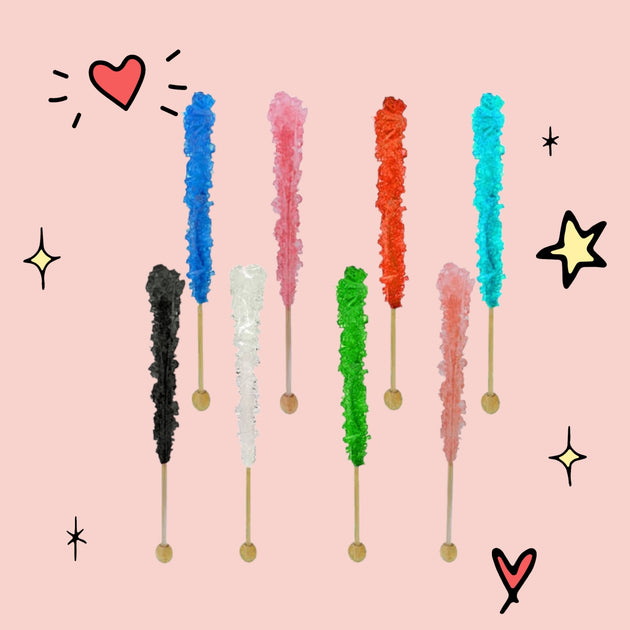Colorful rock candy sticks in various shades including blue, pink, red, turquoise, green, and black, arranged on a light pink background.