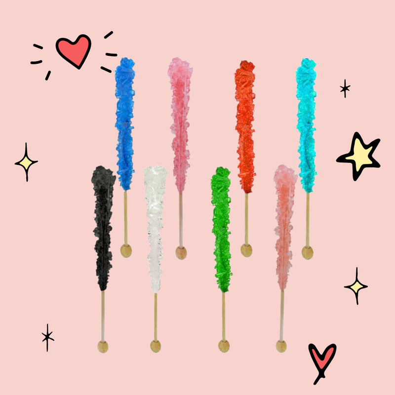 Colorful rock candy sticks in various shades including blue, pink, red, turquoise, green, and black, arranged on a light pink background.
